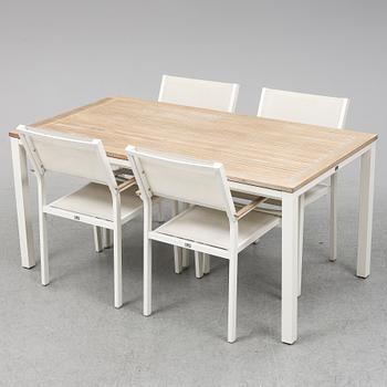 A garden table with four chairs, Gloster.