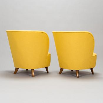 A pair of mid-20th-century armchairs.