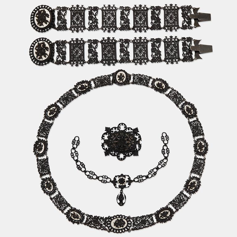A Berlin steel and iron parure comprising a necklace, two bracelets and a brooch.