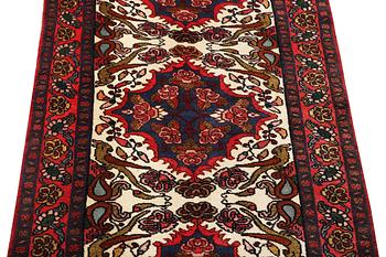 An oriental runner carpet, c. 295 x 95 cm.