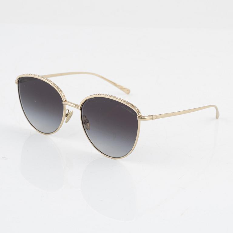 Chanel, a pair of gold tone and crystal sunglasses.