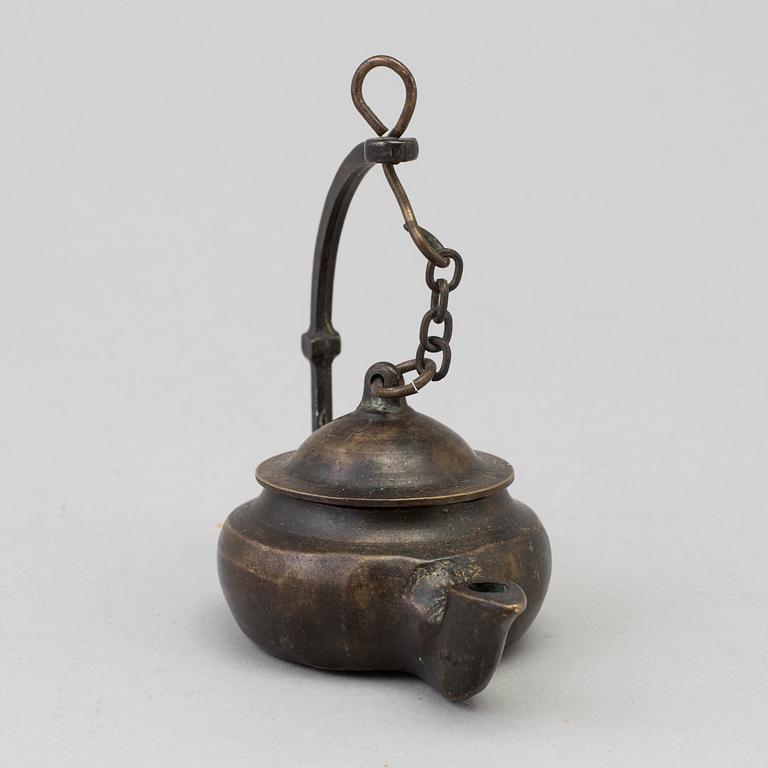 An 18th century bronze oil lamp.