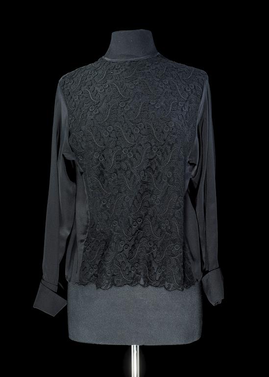 A black silk lace blouse by Yves saint Laurent.