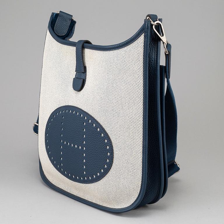 HERMÈS, a canvas and blue leather crossbody bag, "Evelyn".