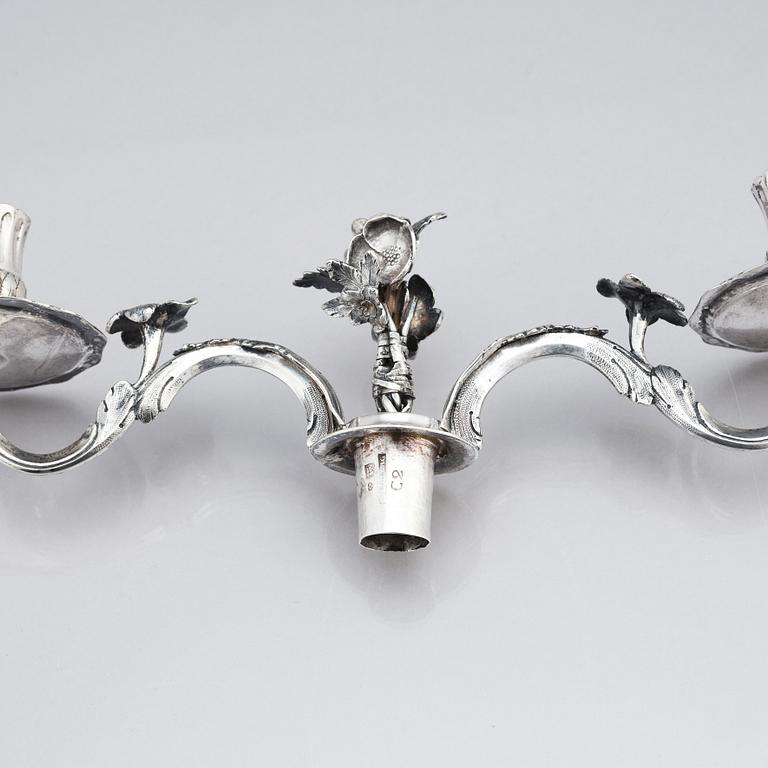 A pair of Swedish 18 century silver candelabras, mark of Lars Åkerblom Gävle 1775, arms by Christian Kullberg.