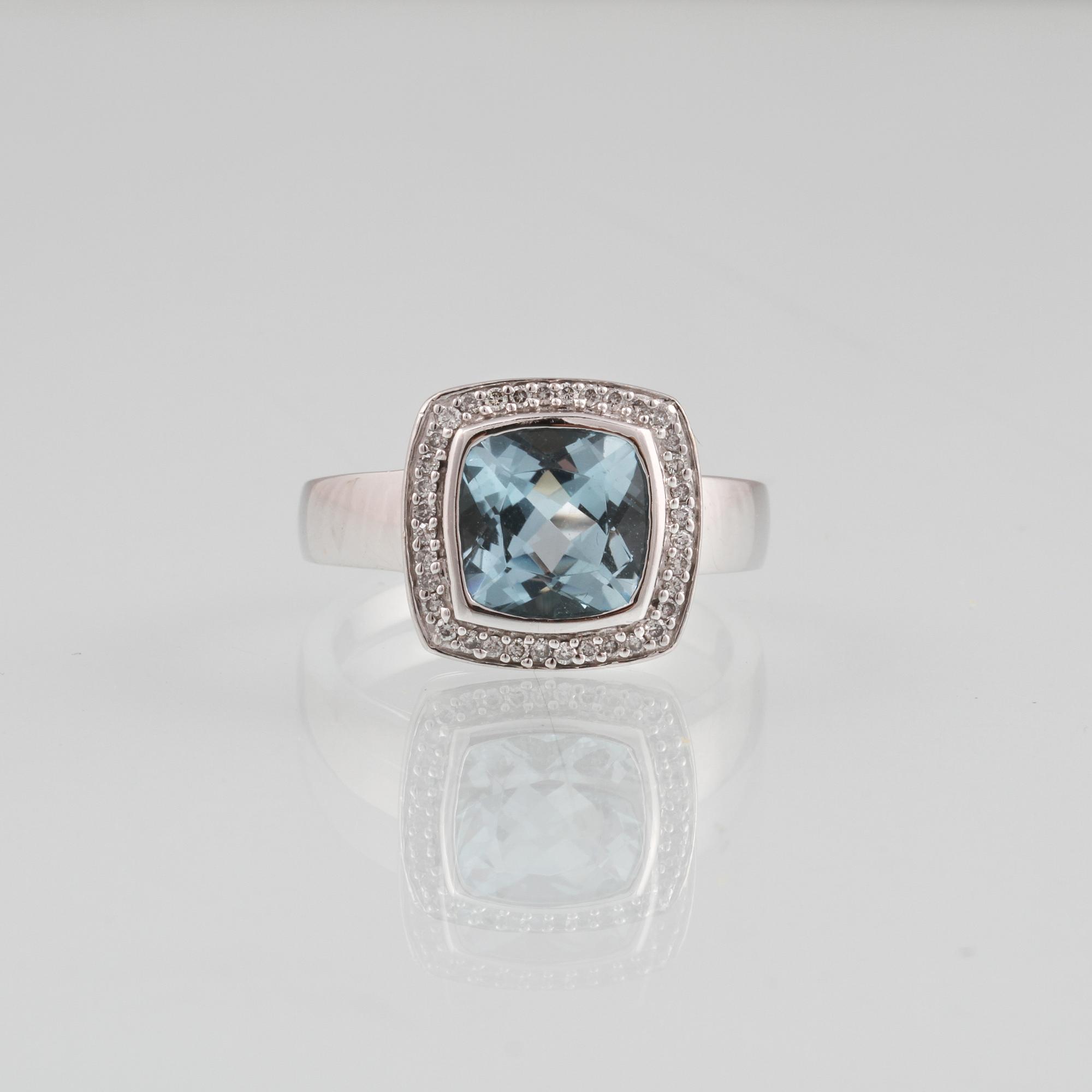RING, 18K vitguld med fasettslipad blå topas samt 36 briljantslipade diamanter, ca 0.18 ct. Vikt 8,2 gram.