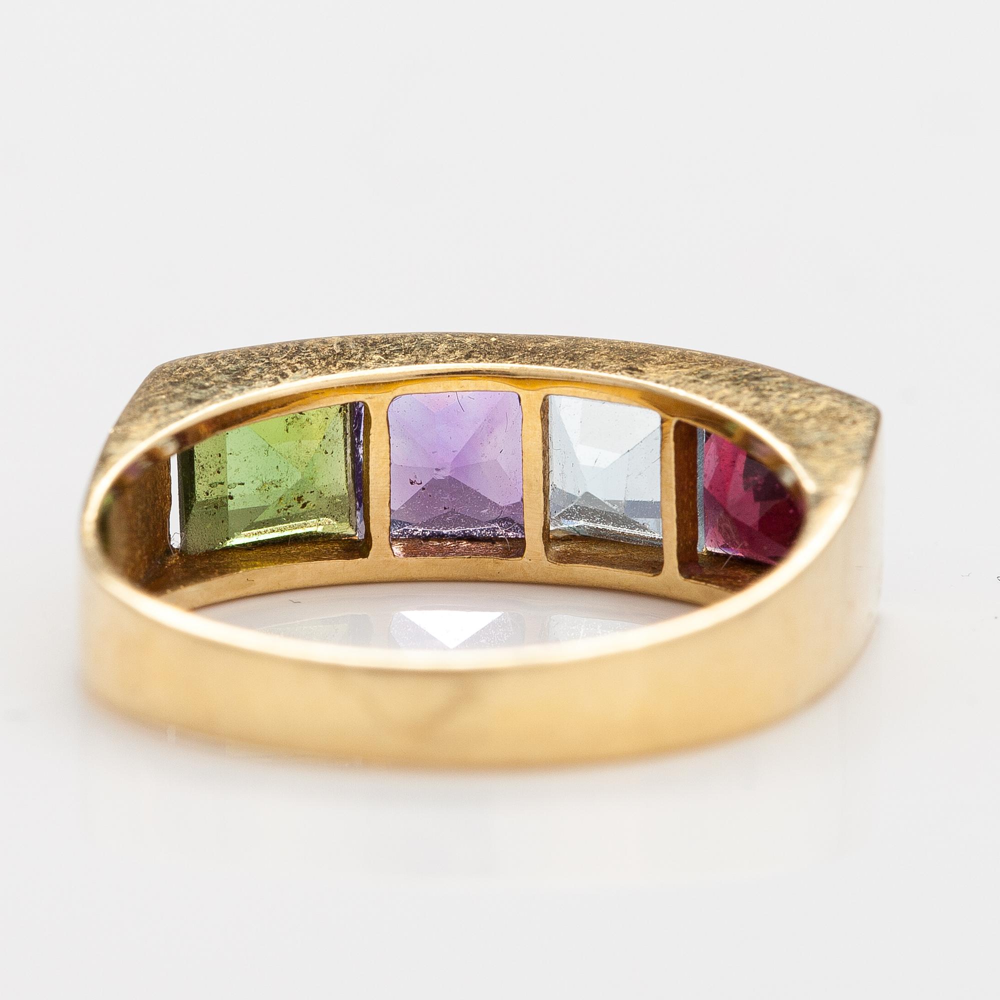 An 18K gold ring with an amethyst, garnet, topaz and peridote.
