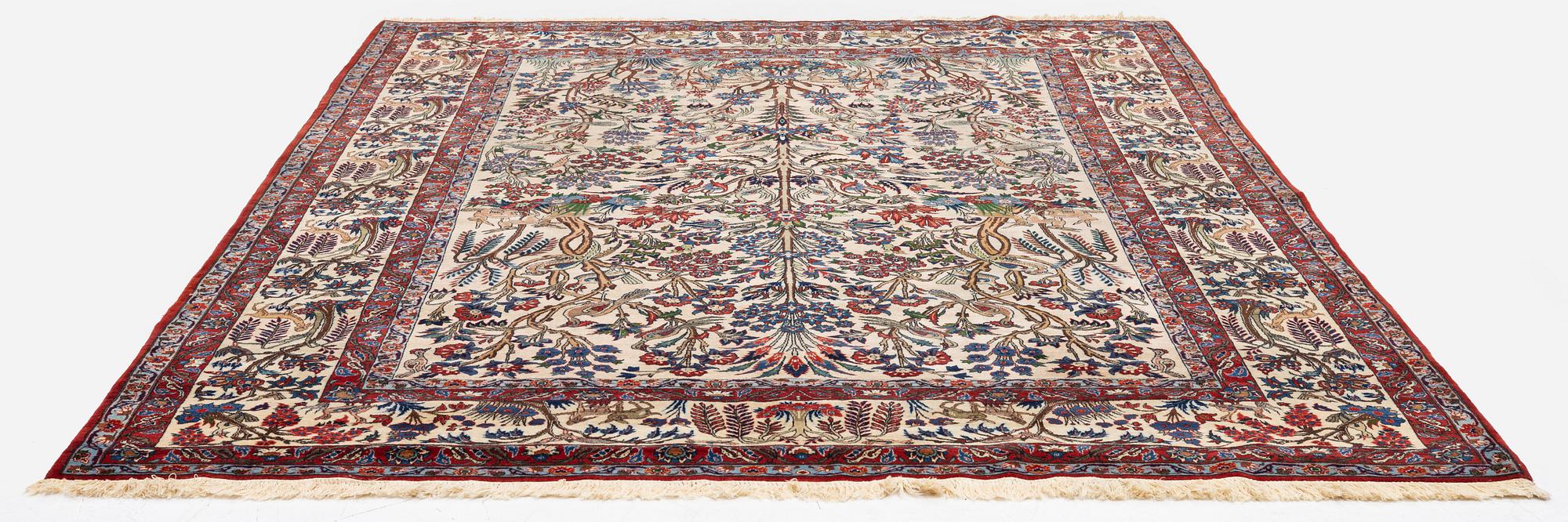 A semi-antique Qum carpet, Central Persia, c. 312 x 215 cm.