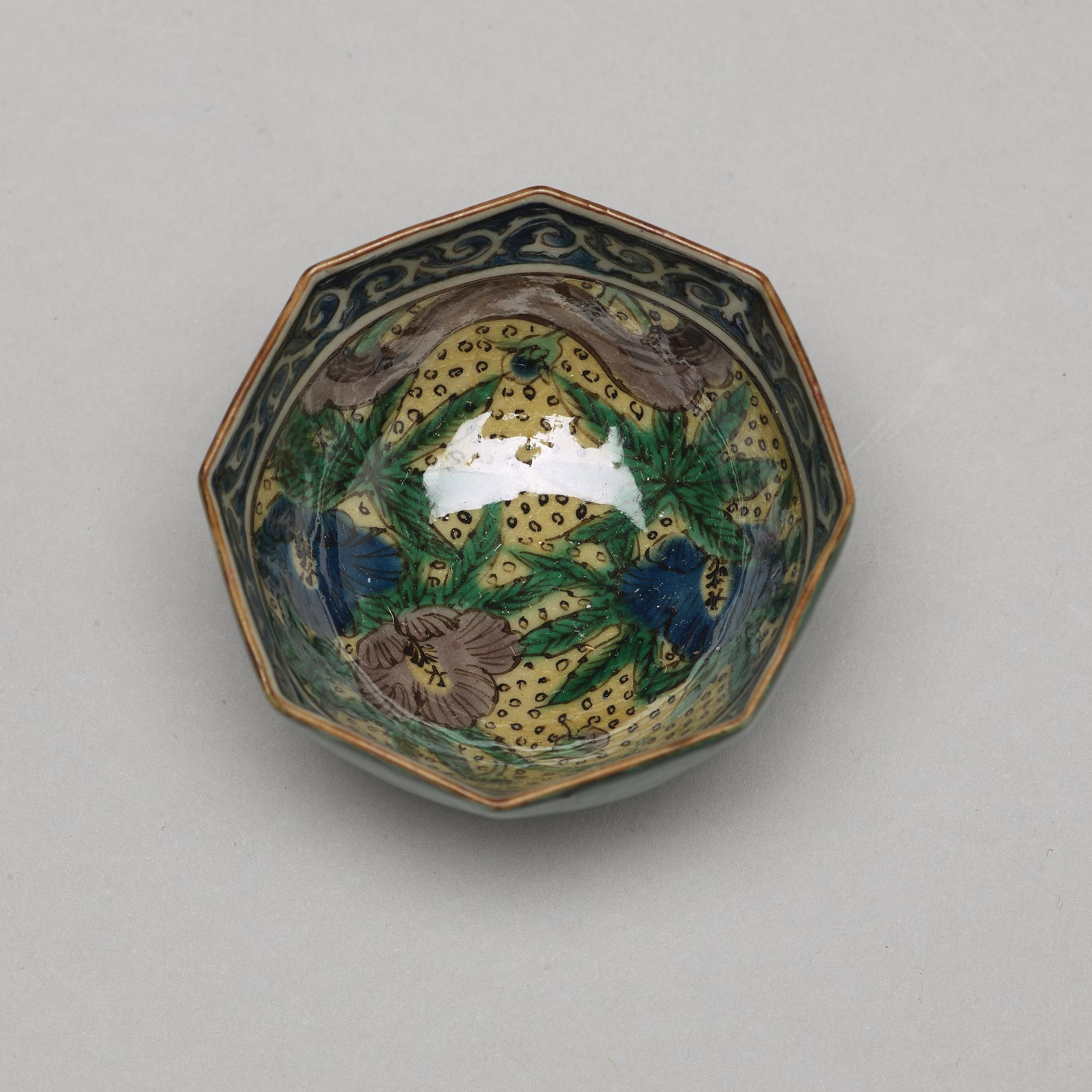 A set of two Japanese figures and a set of six cups in a wooden box, early 20th Century.