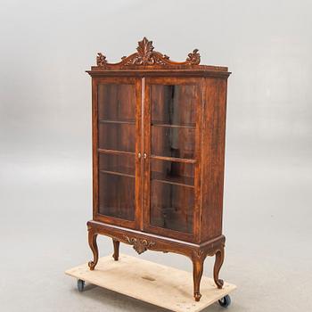 A 1940s Rococo style display cabinet.