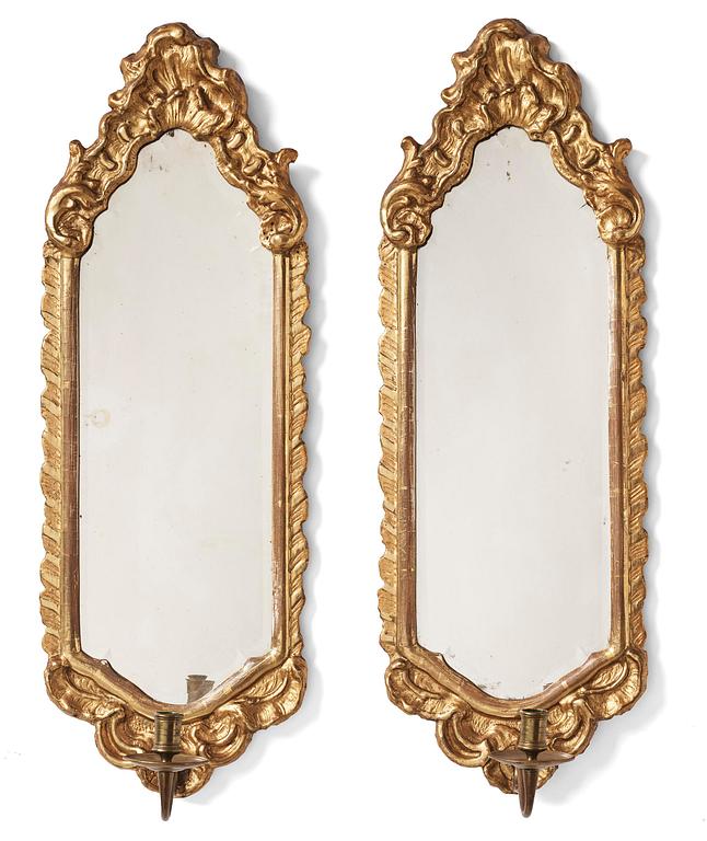 A pair of presumably German rococo giltwood one-branch mirrored wall-sconces, mid 18th century.