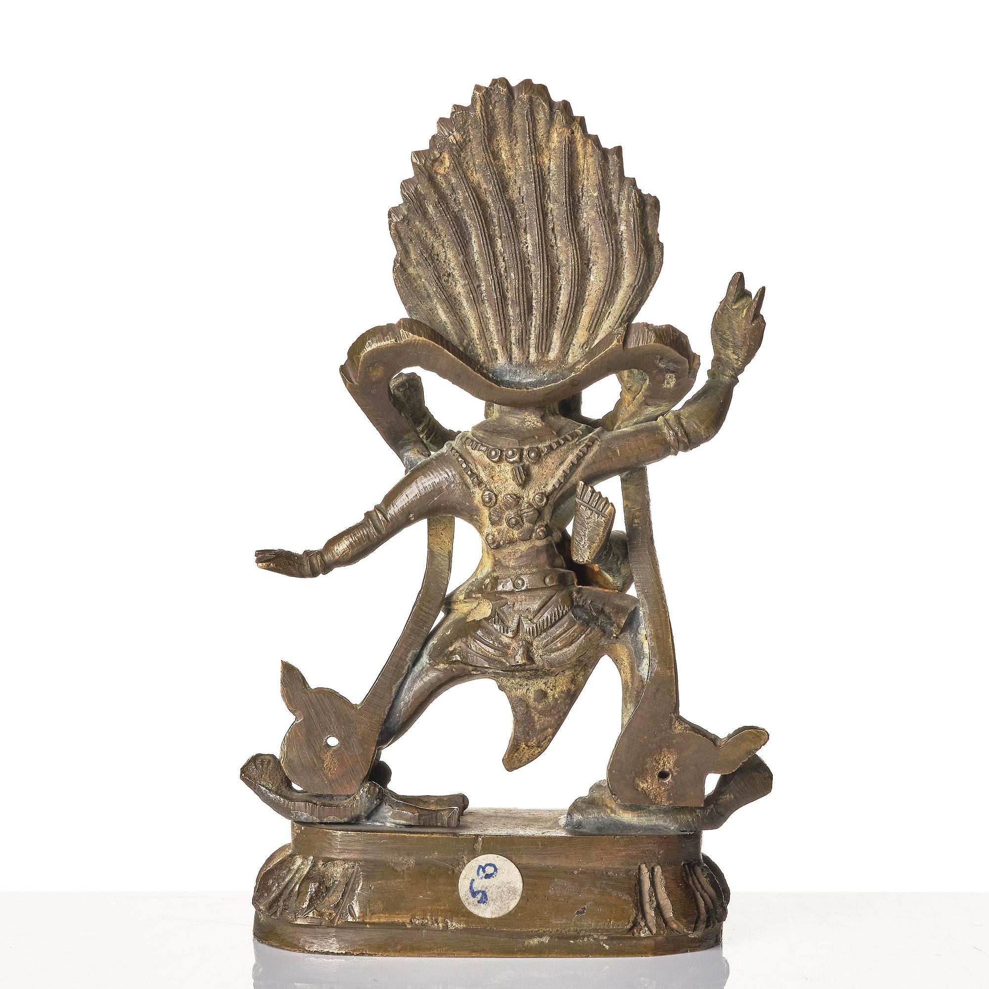 A bronze deity and a brass sacrificial bowl, Tibet, circa 1900.