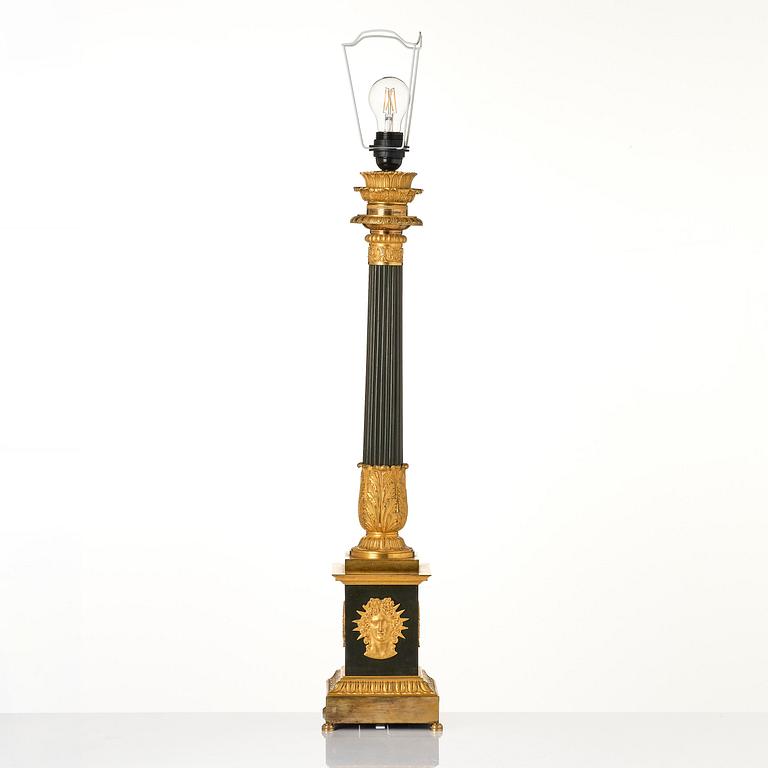 A French late Empire ormolu and patinated bronze lamp, first part 19th century.