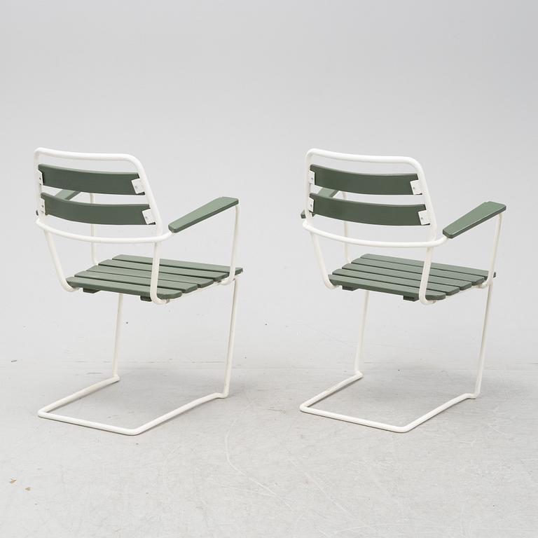 A mid  20th Century garden set with a table and four chairs.