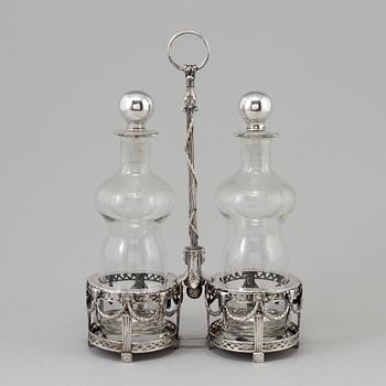 A silver bottle holder with glass bottles, possibly from Holland. From around year 1900.