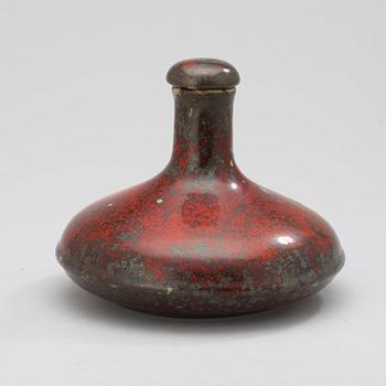 A Hans Hedberg faience bottle with stopper.