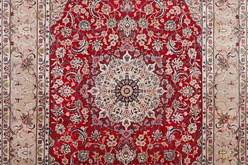 A signed Esfahan carpet, part silk, c. 298 x 206 cm.