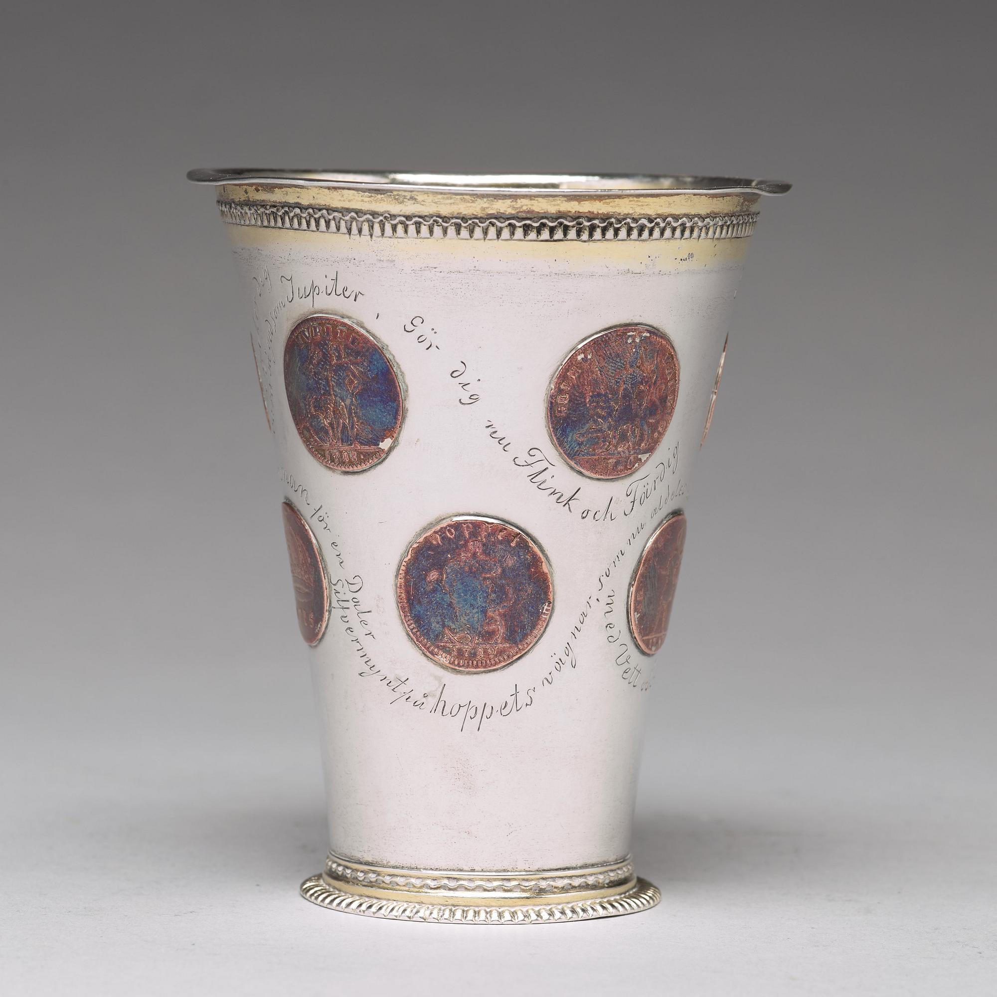 A Swedish 18th century parcel-gilt silver beaker with copper coins, mark of CM Ekman, Eksjö (1729-1738).