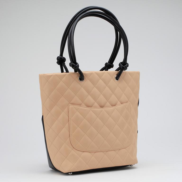 CHANEL, a beige leather "Large Shopping" handbag.