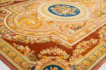 A carpet in savonnerie technique, ca 560 x 429 cm, Louis XVI style.