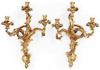 579. A pair of Louis XV-style late 19th century gilt bronze three-light wall-lights.