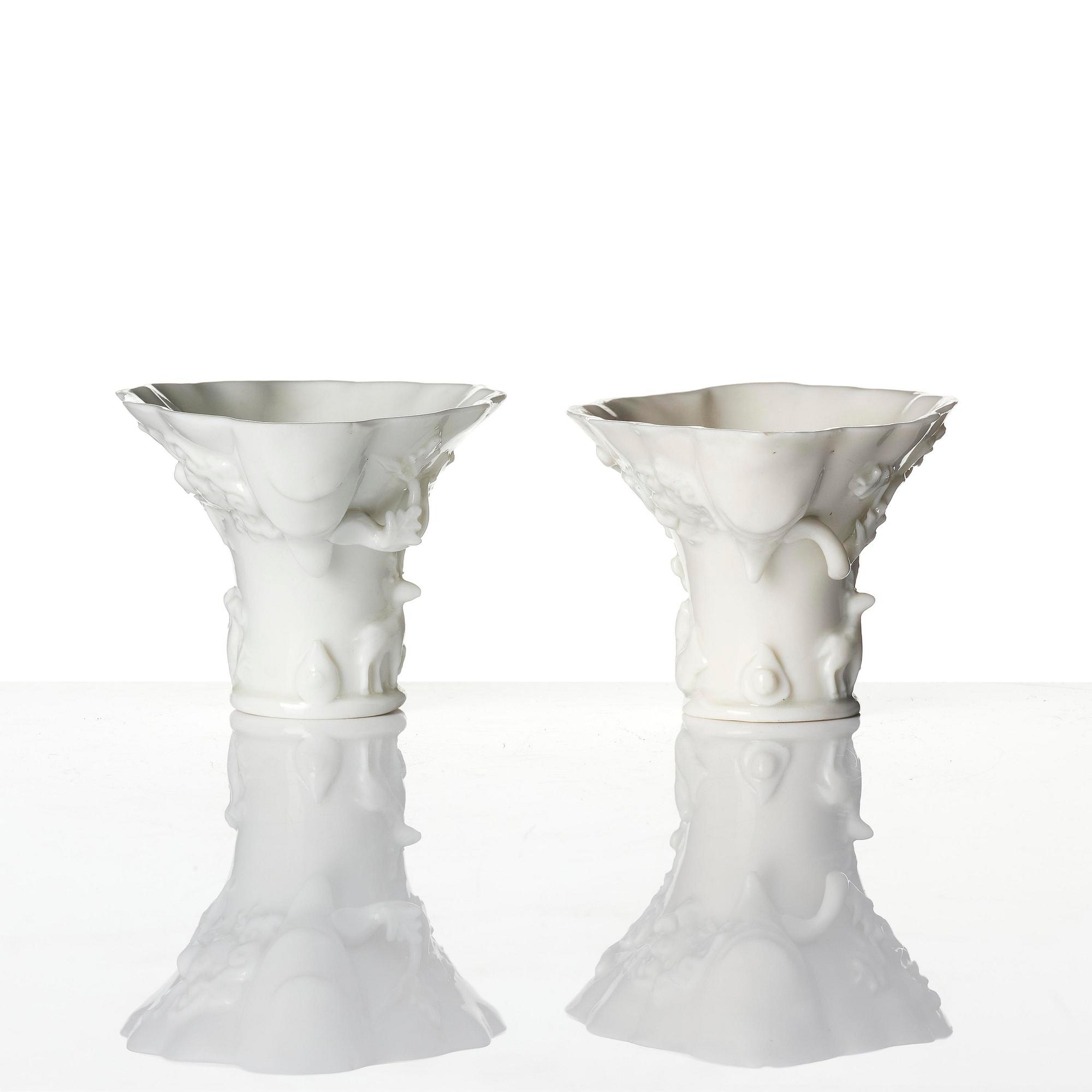 A pair of blanc de chine rhinoceros libation cups, Qing dynasty, Kangxi (1662-1722).