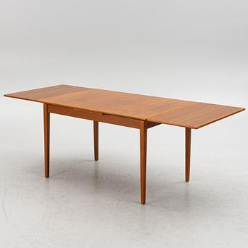 A dining table with four chairs, mid 20th century.