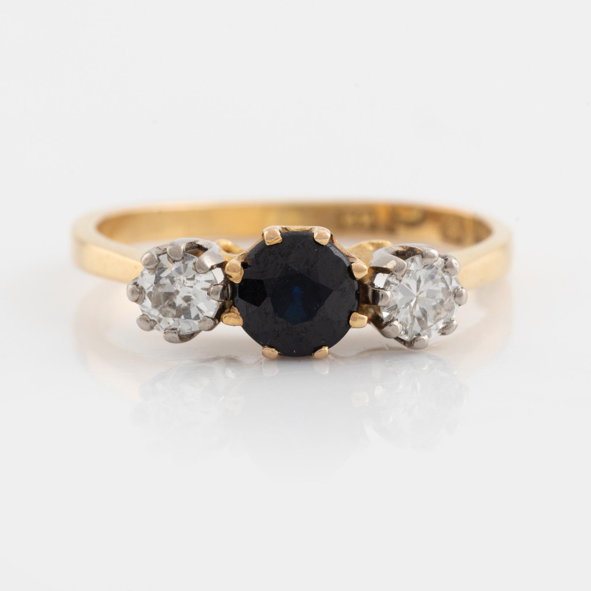 An 18K gold ring set with a sapphire and old-cut diamonds.