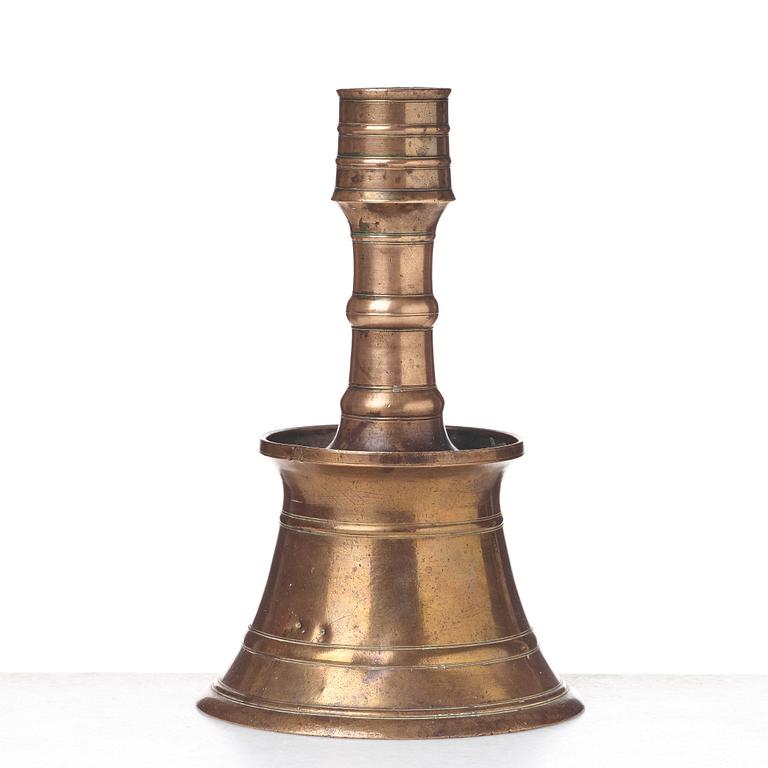 A CANDLESTICK, bronze/copper alloy, Ottoman, Turkey 16th-17th century, height 24 cm, the foot diameter 15,5 cm.