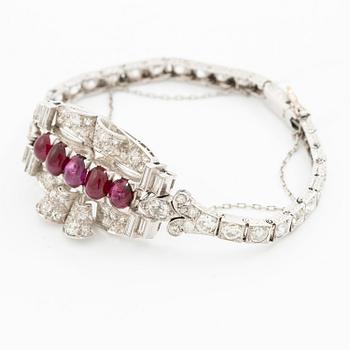 A bracelet platinum set with old- and baguette-cut diamonds and cabochon-cut rubies, circa 1930-40s.
