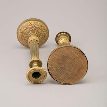 A pair of early 19th century ormolu candlesticks.