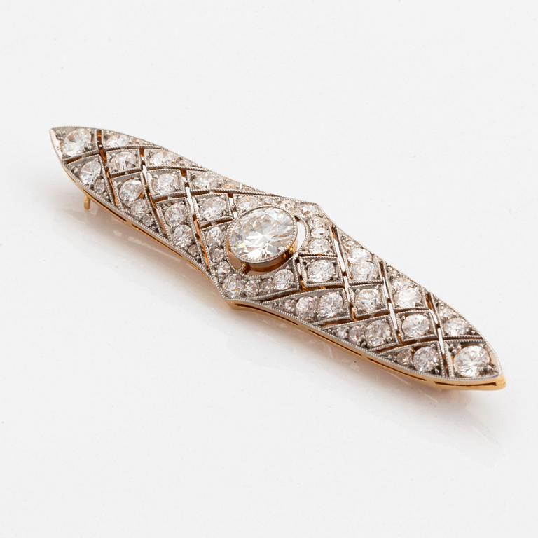 A platinum and 14K gold brooch set with an old-cut diamond weight ca 1.05 cts quality ca H si.