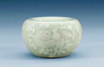 A slip decorated celadon bowl, Qing dynasty, 19th Century, with Kangxis six character mark.