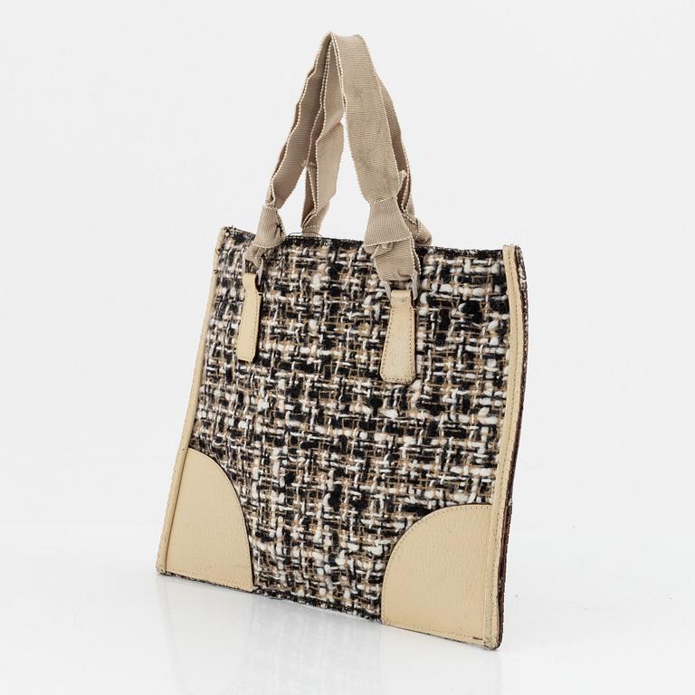 Prada, a tweed and leather bag.