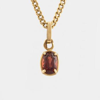 Pendant with chain with red stone, possibly garnet.