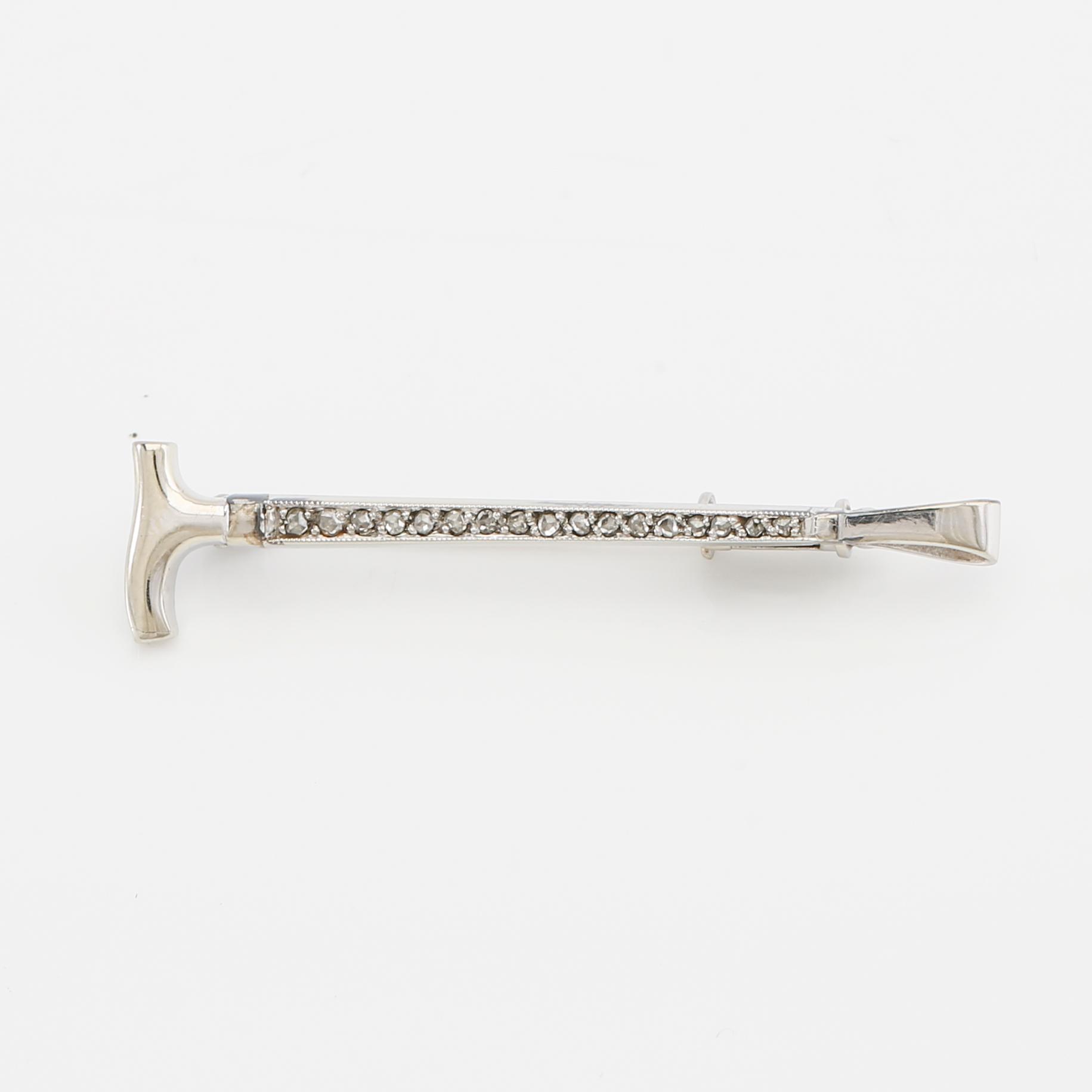 Brooch in 18K white gold shaped like a riding crop with rose-cut diamonds, G. Dahlgren & Co Malmö 1944.