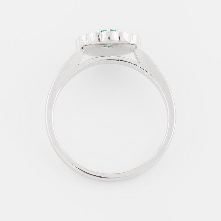 An emerald and brilliant cut diamond ring.