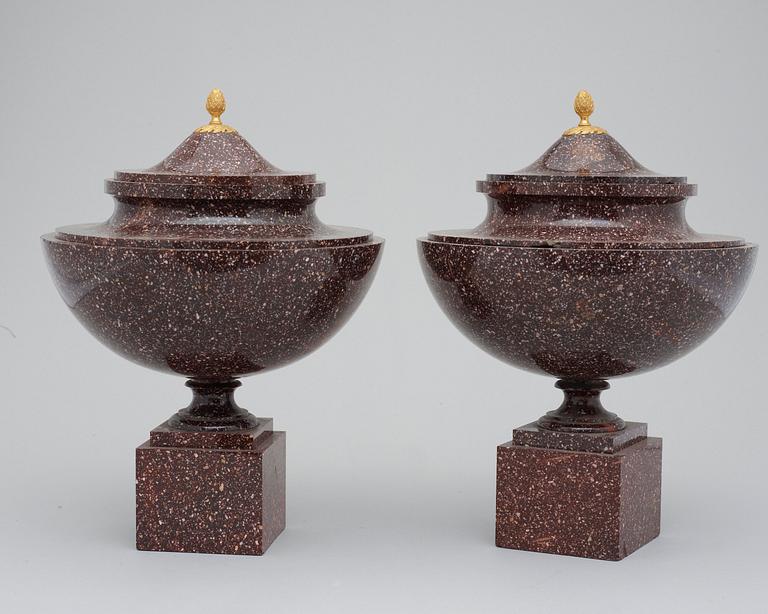 A pair of late Gustavian early 19th century porphyry urns with cover.