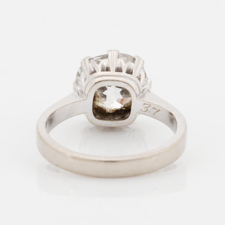 An 18K white gold ring set with a cushion formed old cut-diamond.