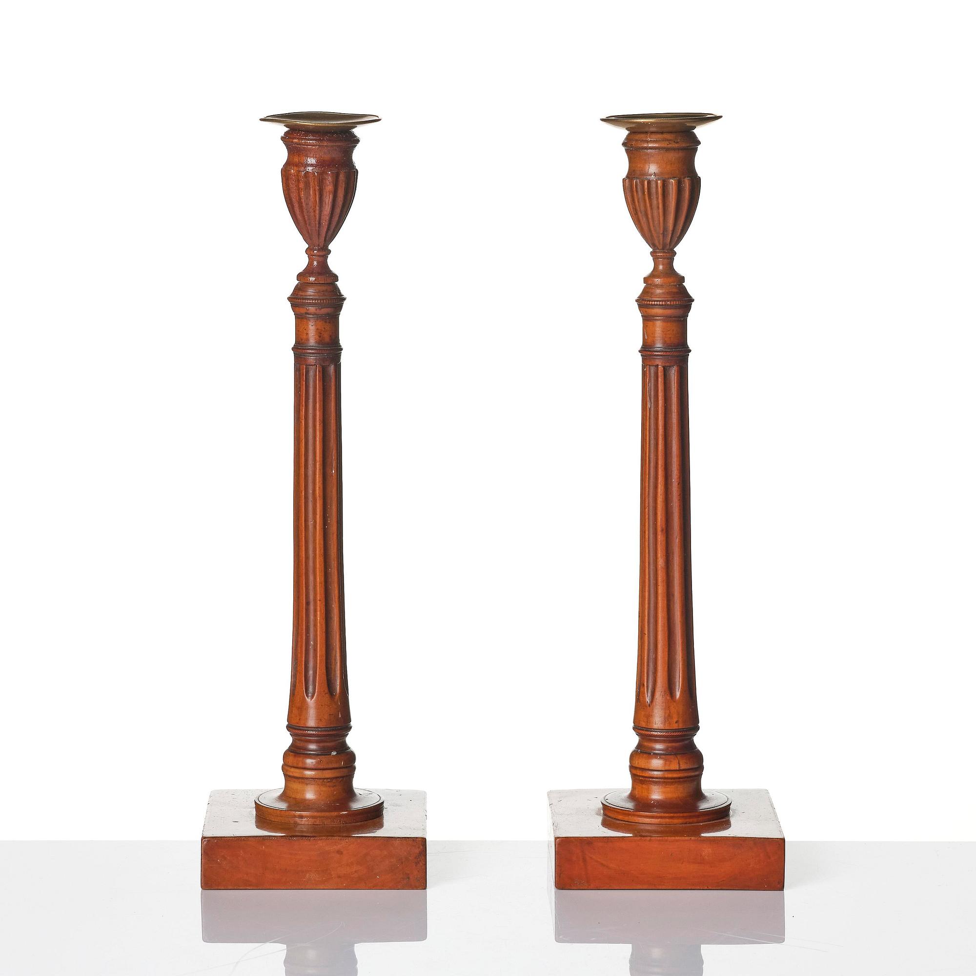 A pair of George III mahogany candlesticks, circa 1800.