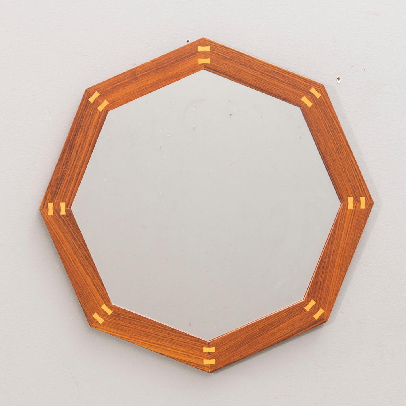 A Sigvard Bernadotte jacaranda mirror for Aktuell Form later part of the 20th century.