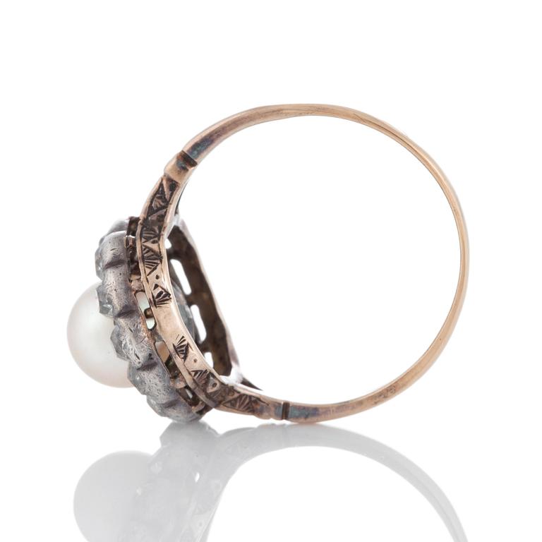 A pearl ring set with old-cut diamonds.