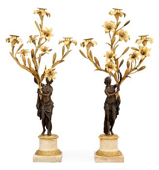 A pair of French Louis XVI-style 19th century three-light candelabra.