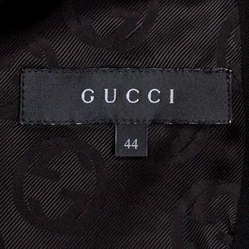 GUCCI, a two-piece suit consisting of jacket and pants.