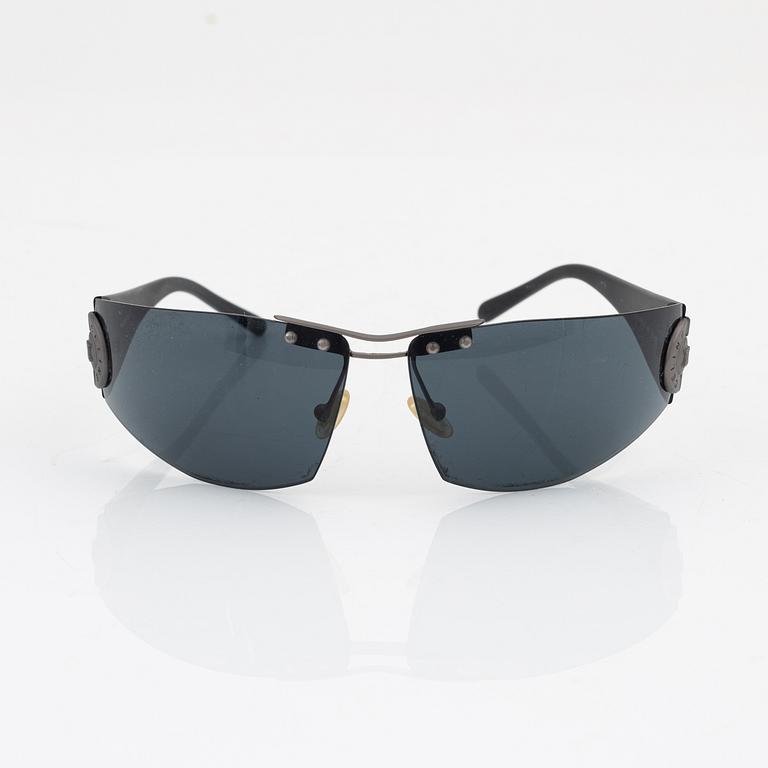 Céline, a pair of black and silver-color sunglasses.