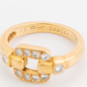 An 18K gold Cartier ring set with round brilliant-cut diamonds.