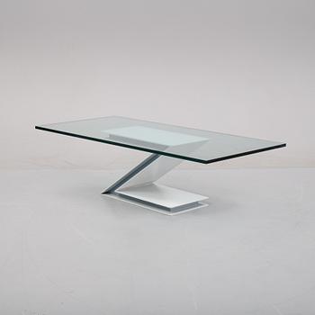 A grey lacquered metal and glass sofa table.