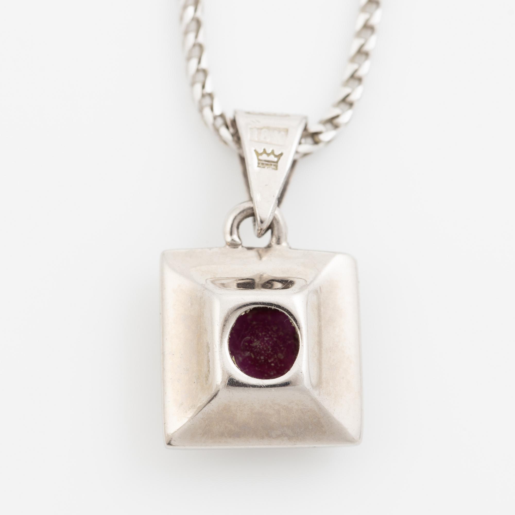 Pendant with chain in 18K white gold featuring a red stone, likely a ruby, and diamonds.