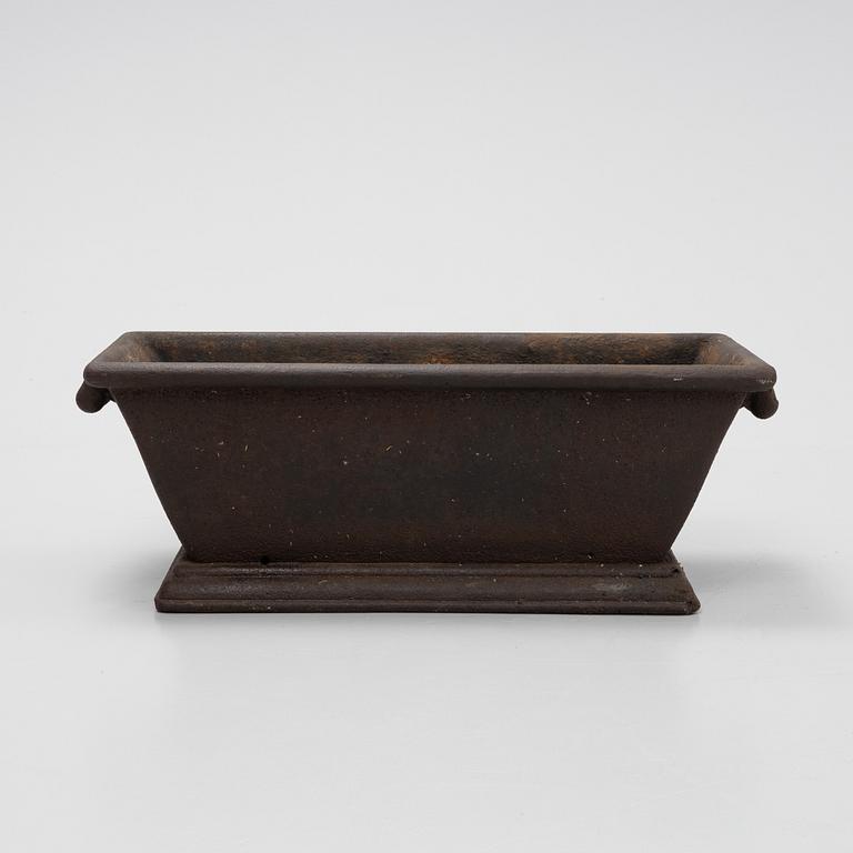A cast iron plant pot, 20th Century.