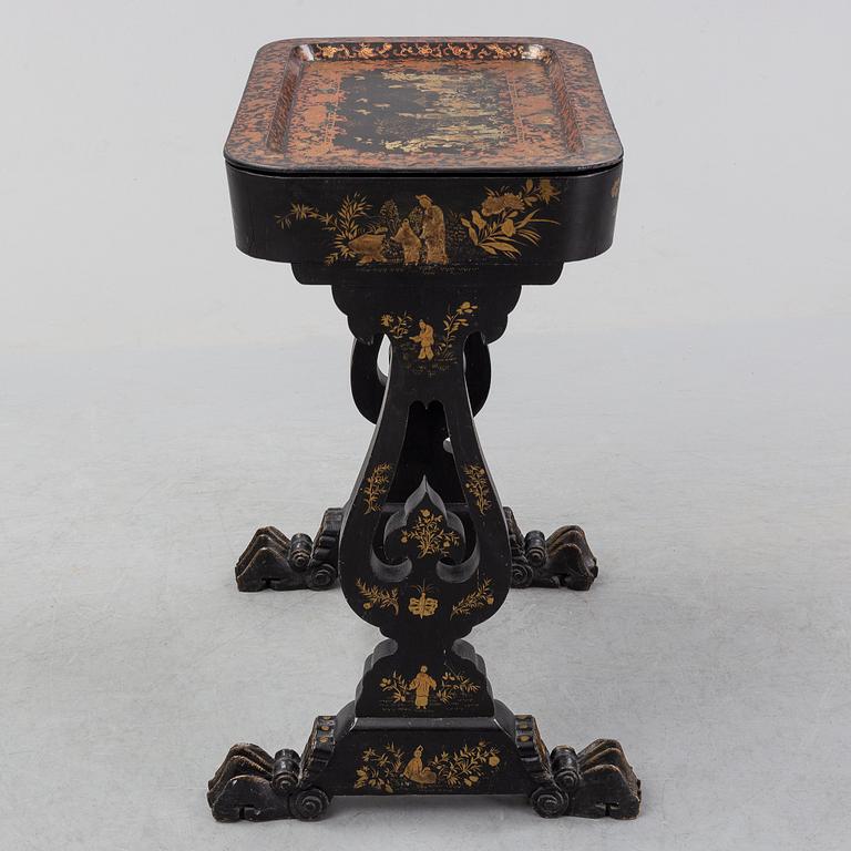 A black chinoiserie sewing table, second half of the 19th Century.